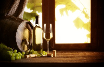 Wine bottle and wineglass on wooden table,